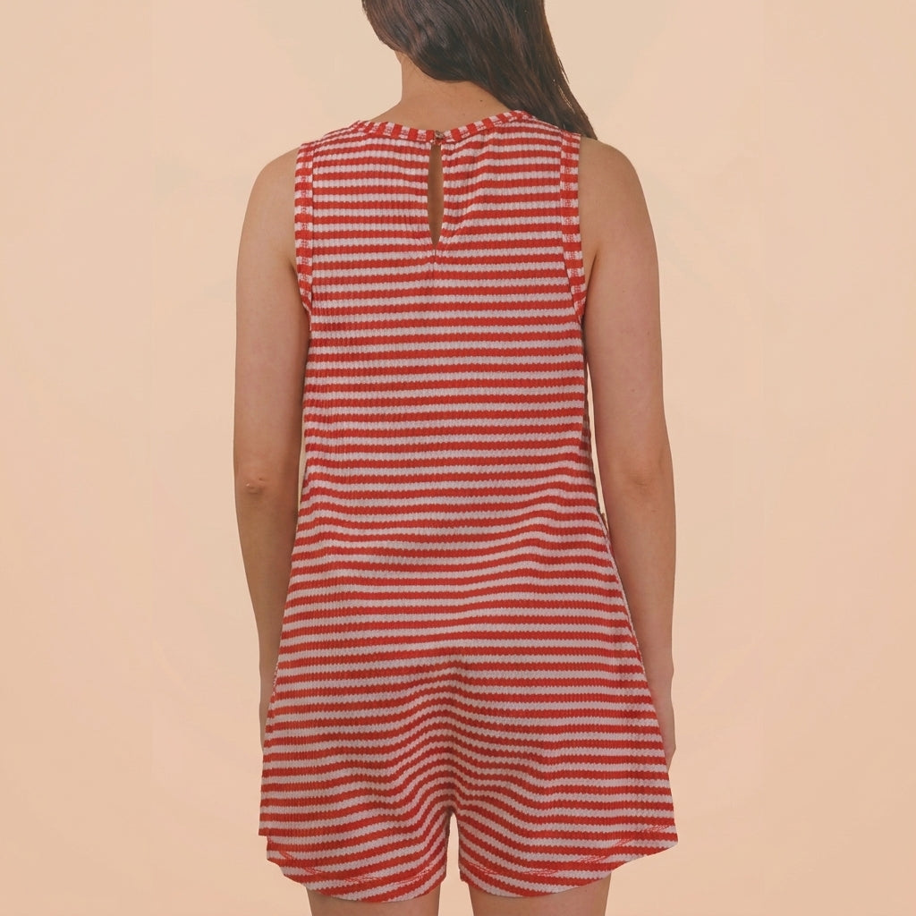 Woman in red and white striped sleeveless dress seen from the back.