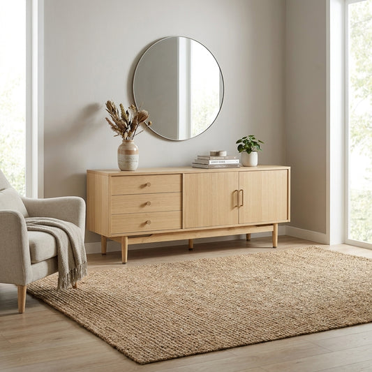 Light wood sideboard with three drawers and two doors.