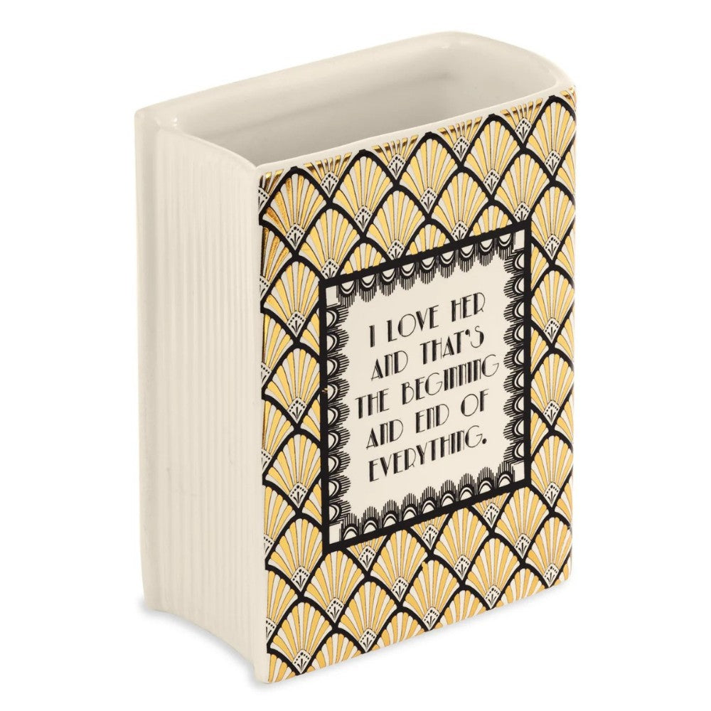 Decorative vase with geometric patterns and romantic quote.