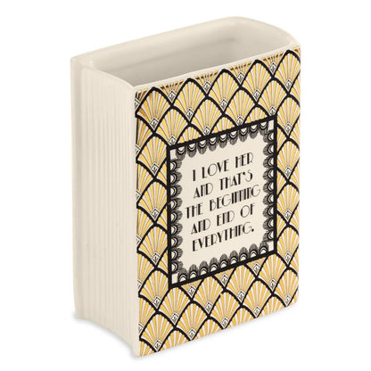 Decorative vase with geometric patterns and romantic quote.