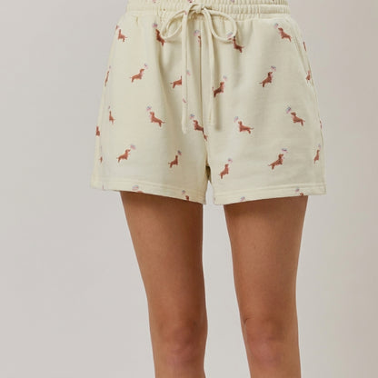 Cream shorts with a dachshund print pattern and drawstring waist.