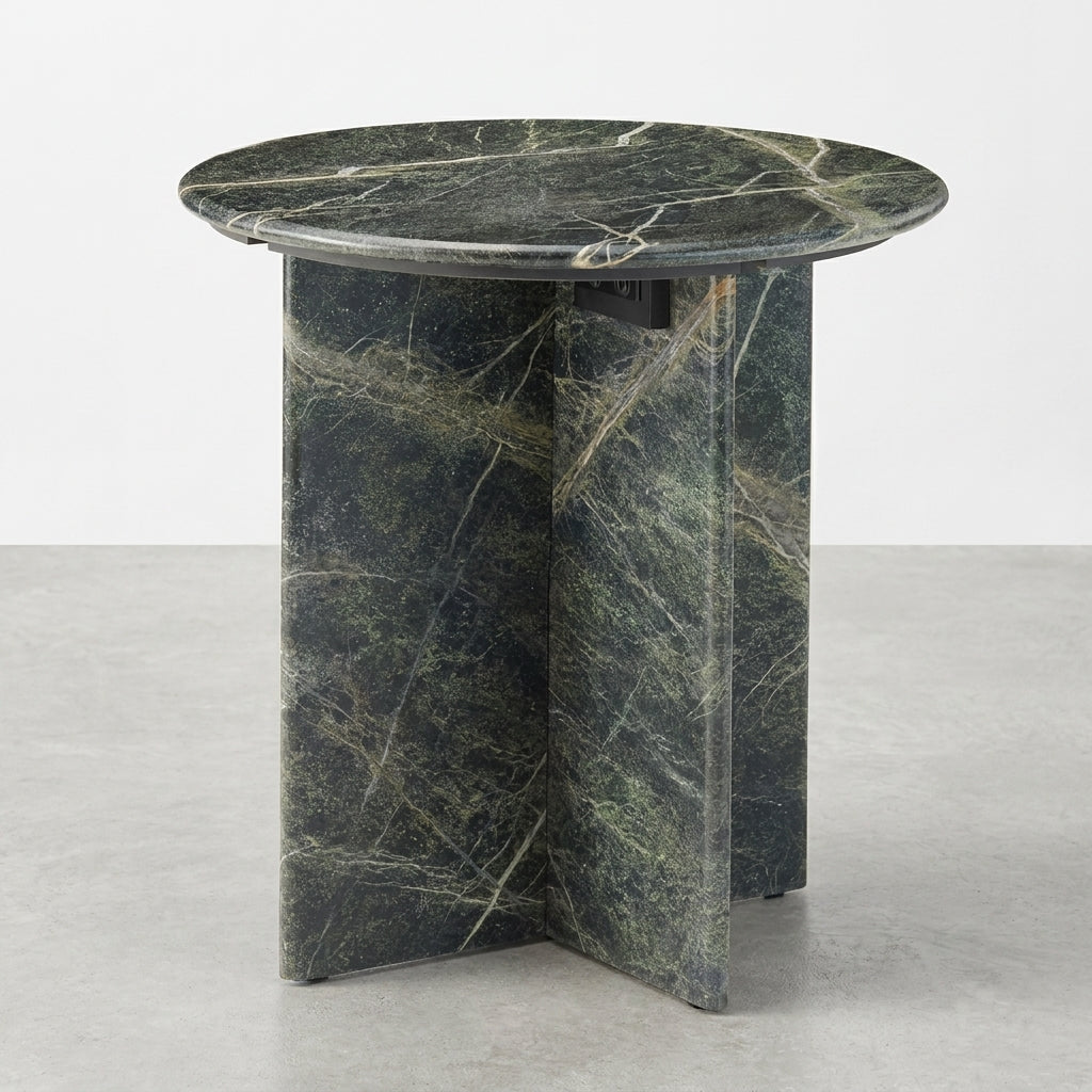 Round marble table with a dark, veined surface and cross-shaped base.