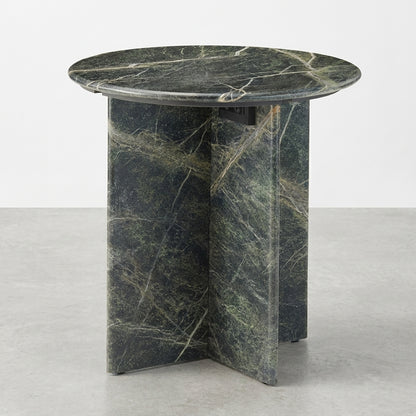 Round marble table with a dark, veined surface and cross-shaped base.