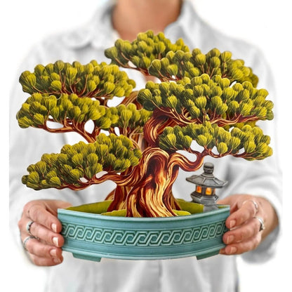 Person holding a bonsai pop-up card with intricate details.