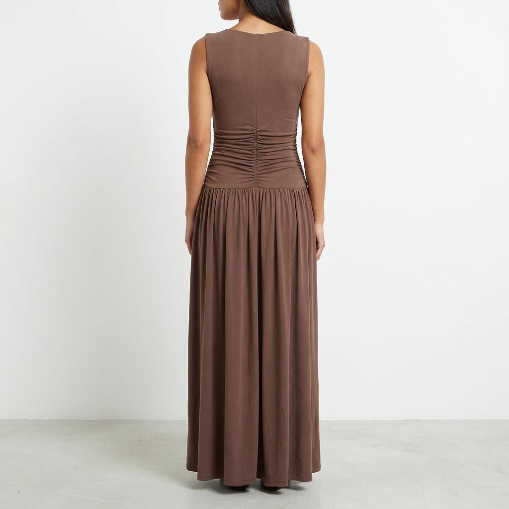 Woman in a long brown dress, facing away.
