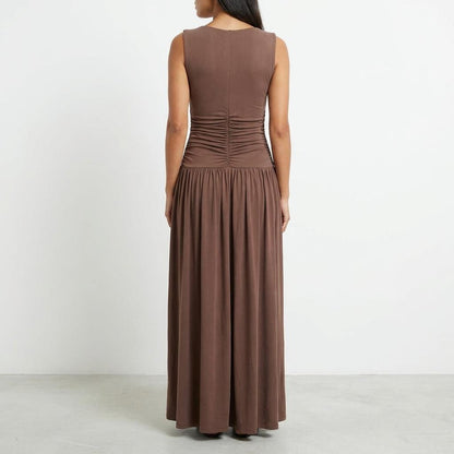 Woman in a long brown dress, facing away.
