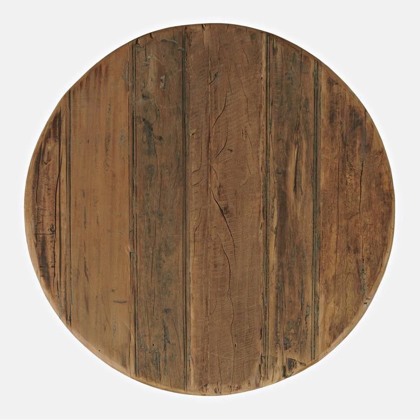 Round wooden surface with a rustic, weathered texture.