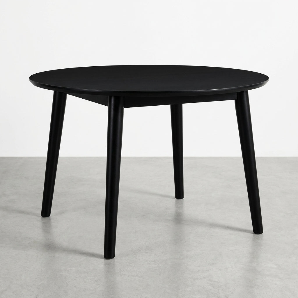 Black round table with four angled legs.