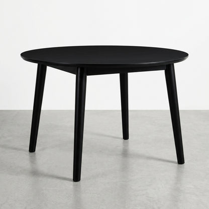 Black round table with four angled legs.