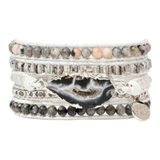 Layered beaded bracelets with a central geode stone accent.