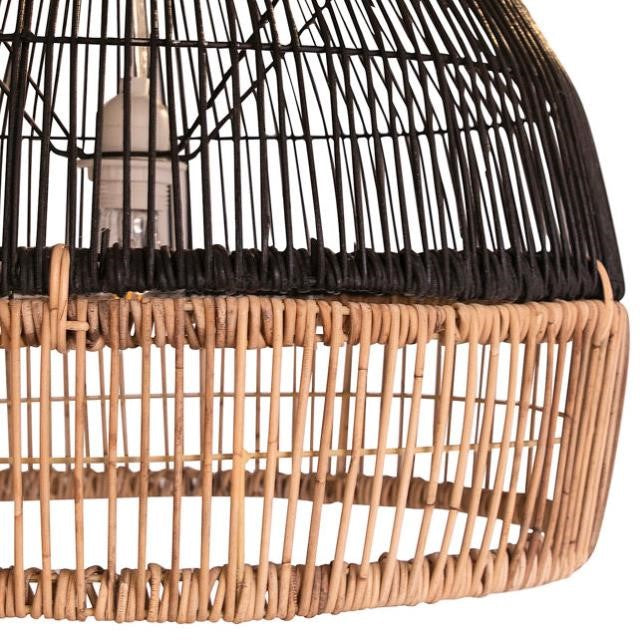 Woven wicker lampshade with visible lightbulb inside.