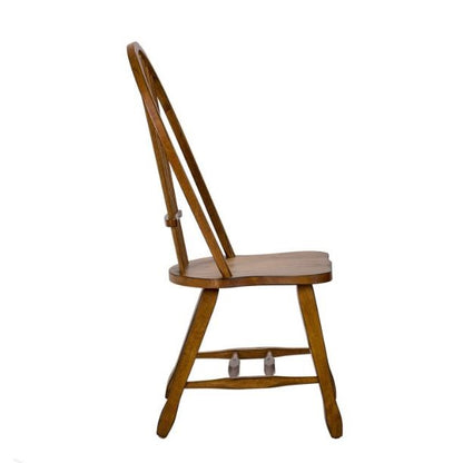 Wooden chair side view with a curved backrest and crossbars.