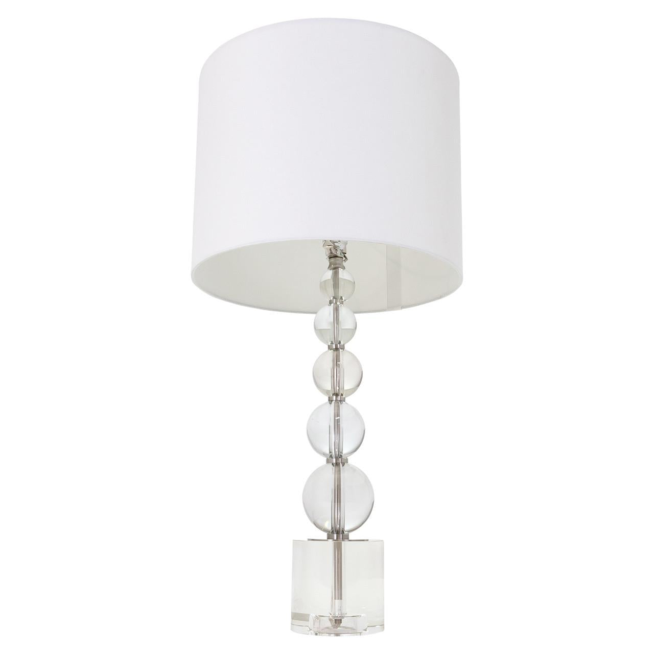 Modern lamp with a white shade and a stacked glass sphere base.