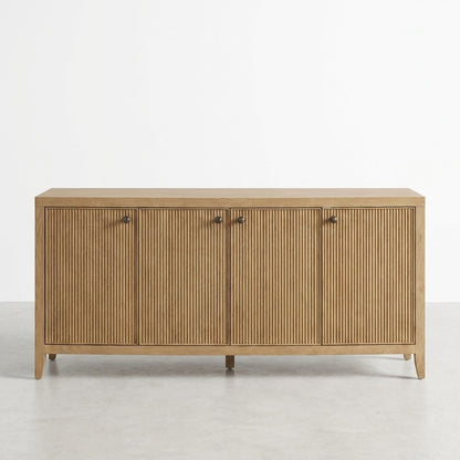 Wooden sideboard with four grooved doors and sleek handles against a white background.