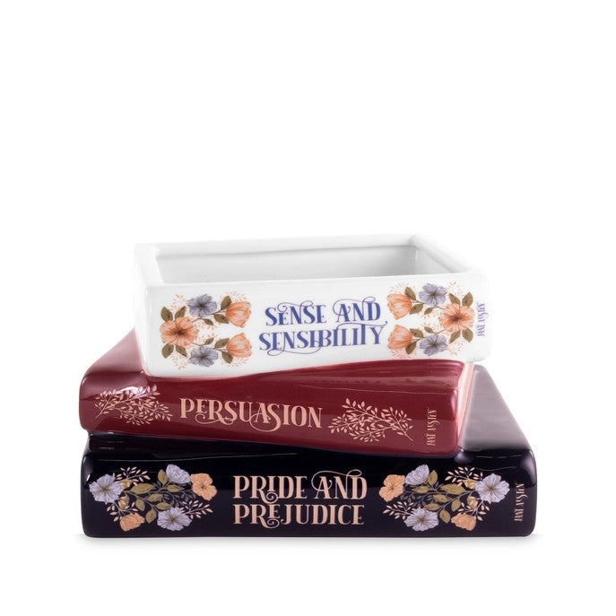 Decorative trays shaped like classic books with floral accents.
