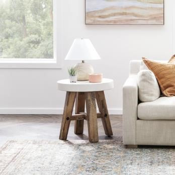 Round stool with a white top and wooden legs.