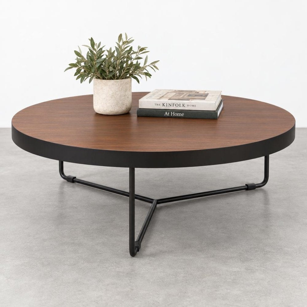 Round table with books and a potted plant on top.