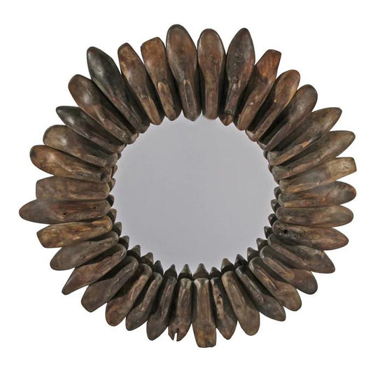 Round mirror with a decorative dark wood petal-like frame.