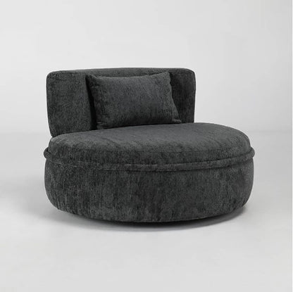 Dark gray, round plush chair with a matching pillow on a light background.