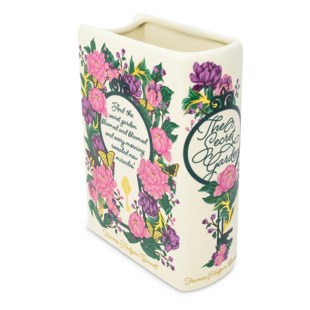 Decorative book-shaped vase with vibrant floral design and text.