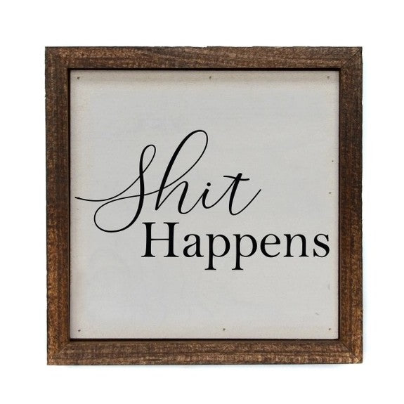 Wooden-framed sign with "Shit Happens" text.