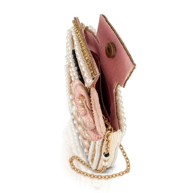 Elegant beaded clutch with pink lining and gold chain handle.