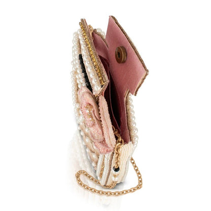 Elegant beaded clutch with pink lining and gold chain handle.