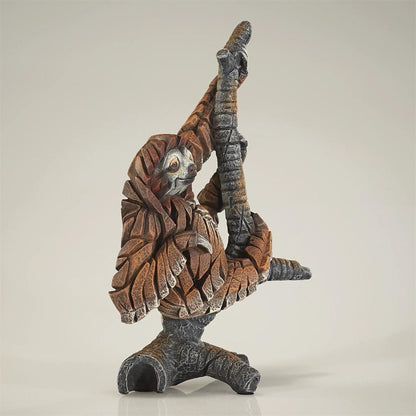 Sloth sculpture with intricate wood-like texture.