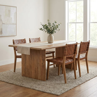 A simple wooden table with sturdy rectangular legs.