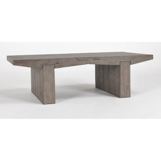Wooden table with slab design and two thick, rectangular legs.