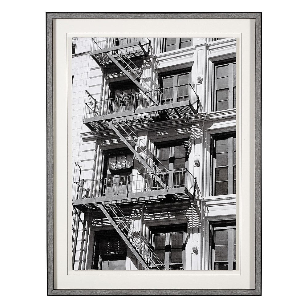 Black and white photo of a building with fire escapes.