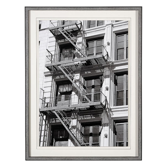 Black and white photo of a building with fire escapes.