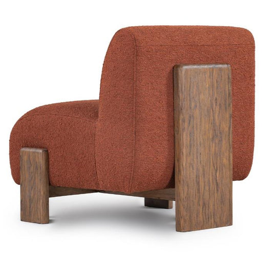 Modern chair with a rust fabric seat and wooden back and legs.