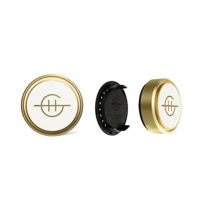 Three gold-edged round objects with logos, one disassembled, on a white background.