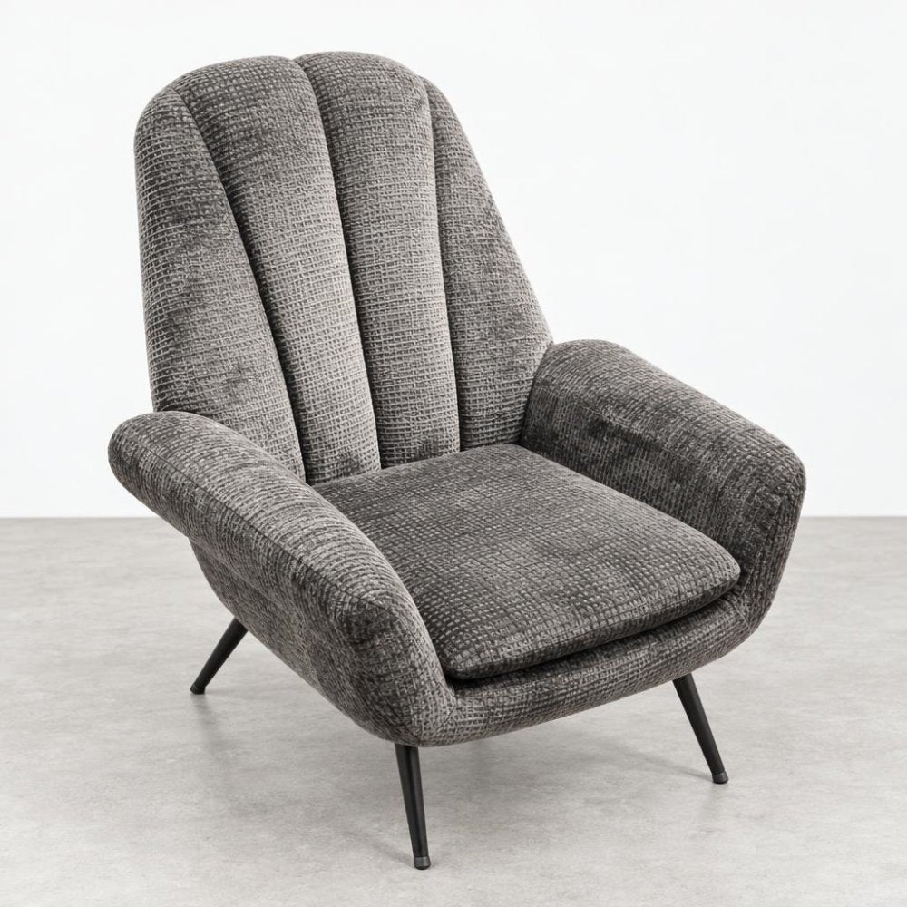 A gray upholstered armchair with a tall channel-tufted back and slim black legs.
