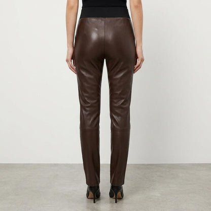 Rear view of brown leather pants worn with black heels.
