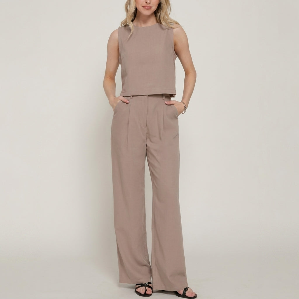 Woman in matching beige crop top and wide-leg pants.