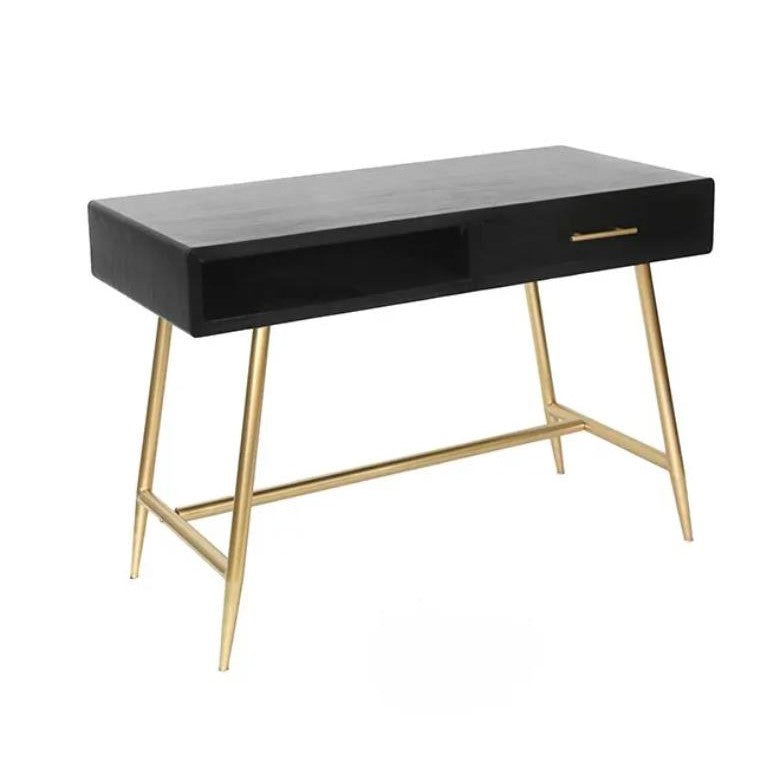 Black desk with golden legs and a drawer.