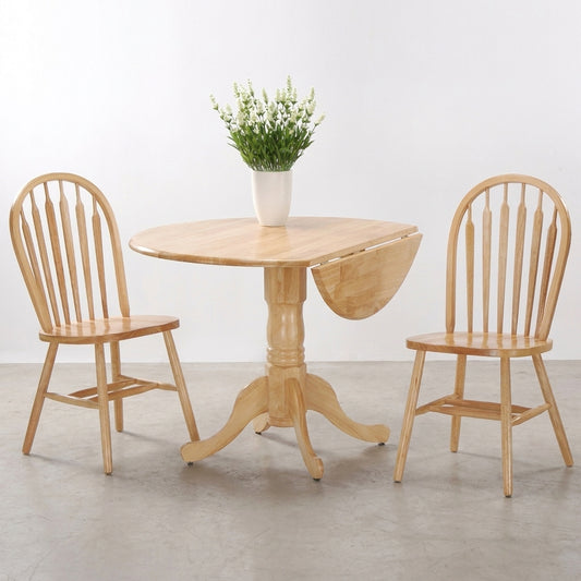 Wooden dining set with vase of flowers on round table, two chairs beside it.