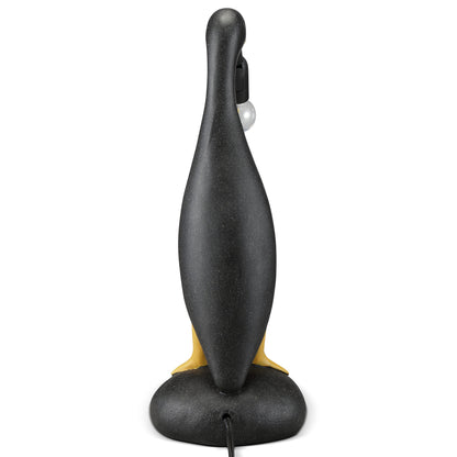 A black penguin-shaped lamp viewed from the back.