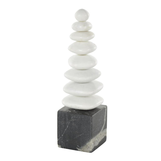 Stones stacked on a dark cube base, forming a pyramid shape.