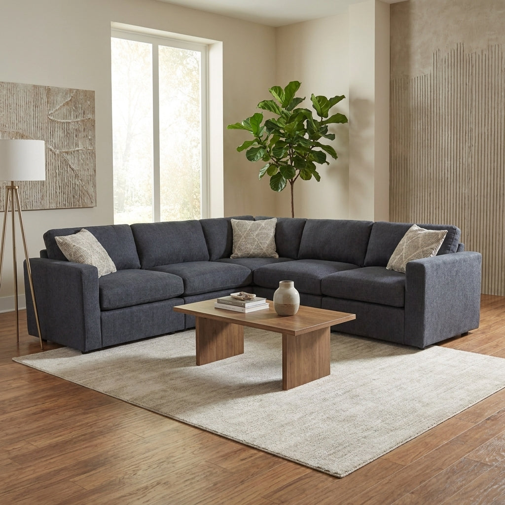 Cozy living room with gray sectional, wooden table, and green plant.
