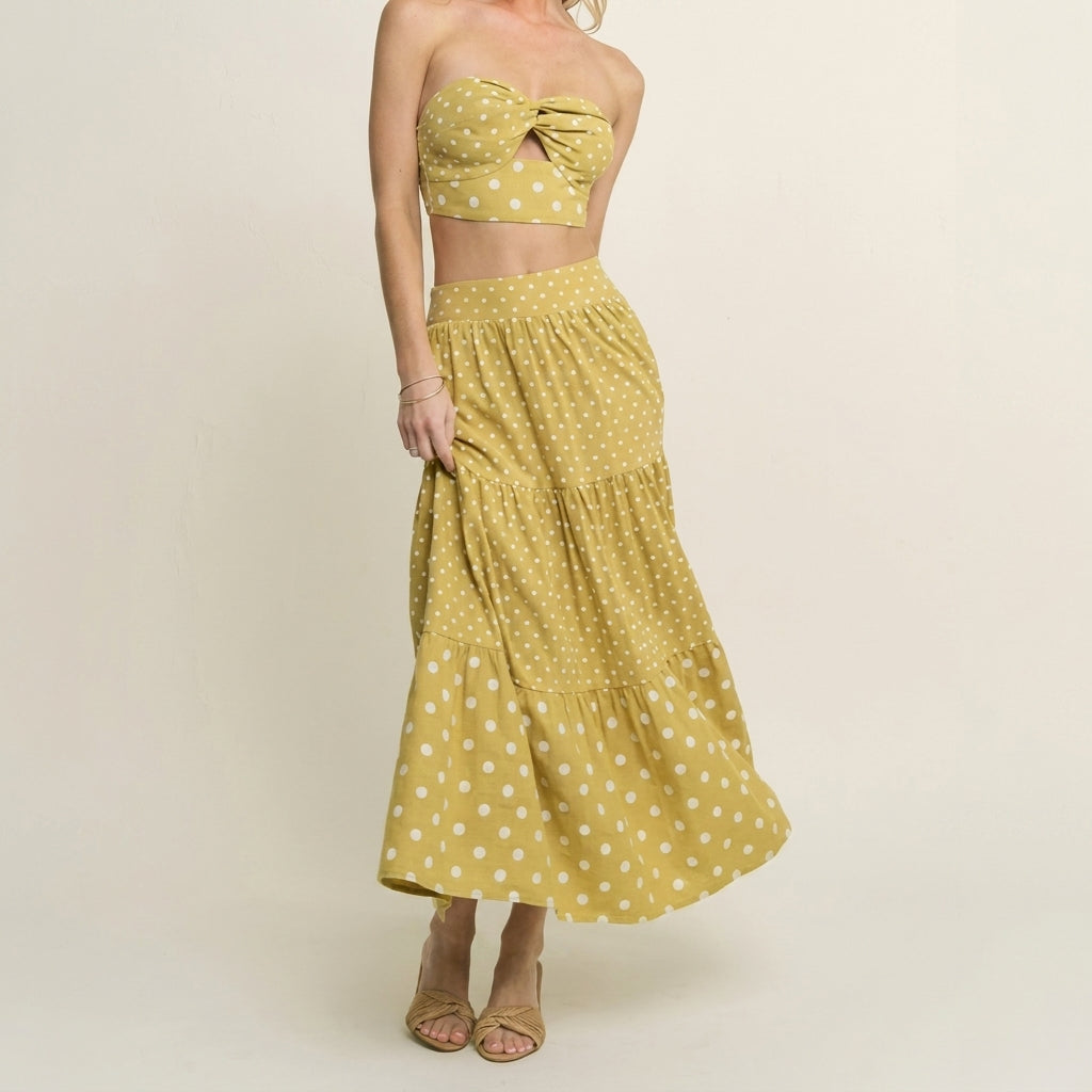 Model in a yellow polka dot crop top and skirt set.