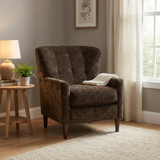 Cozy armchair by a window, beside a lamp and plant on a wooden table.