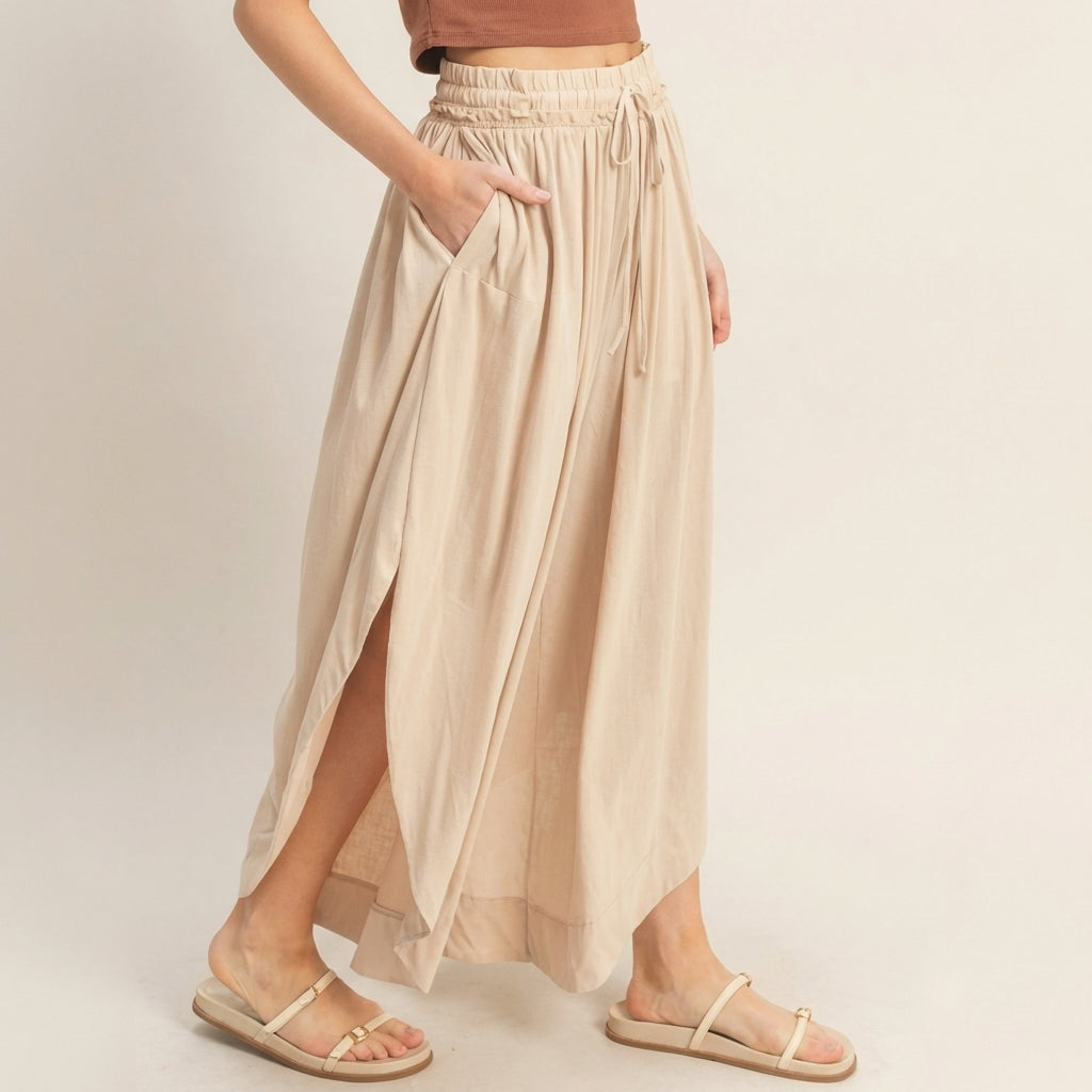 Tan maxi skirt with side slit, pockets, and sandals.