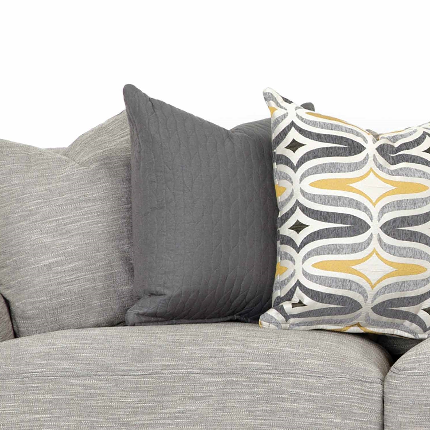 Three decorative pillows on a gray sofa.