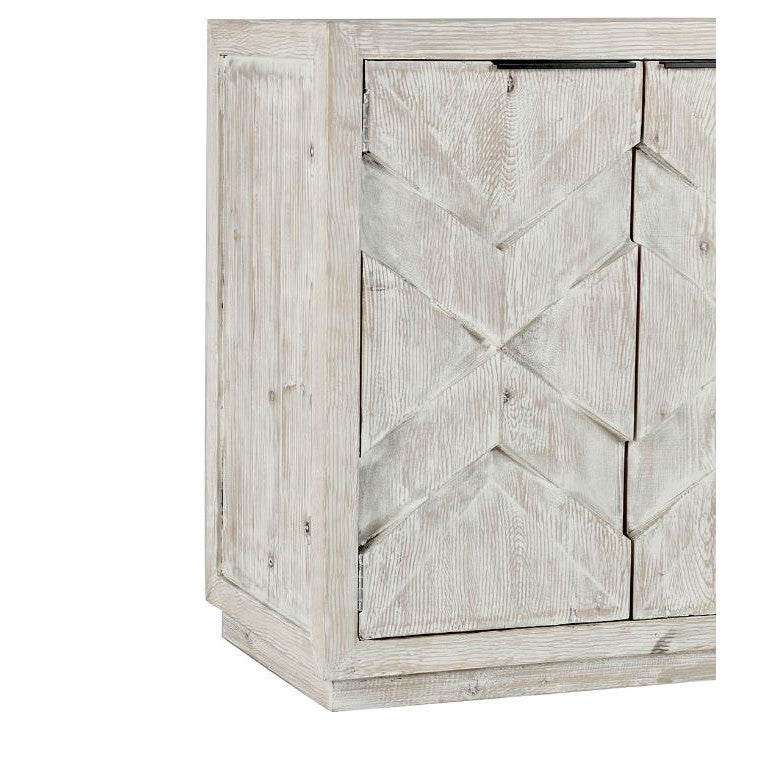 Rustic whitewashed wooden cabinet with geometric patterns.