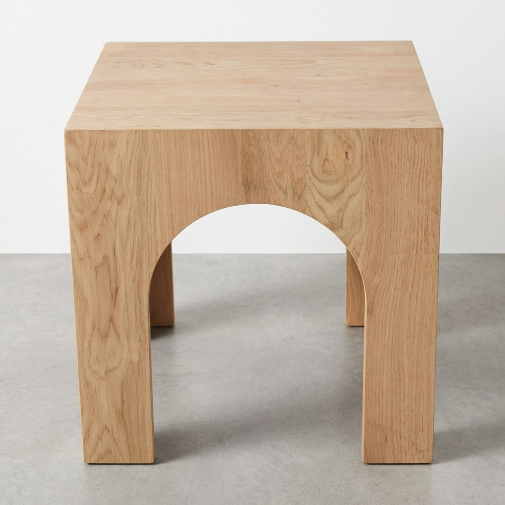 Wooden stool with an arch design and a natural finish.
