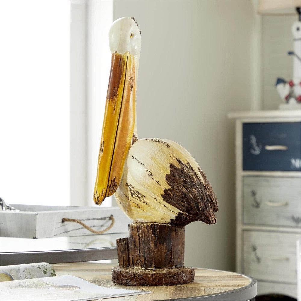 Wooden pelican sculpture on a table in a coastal-themed room.