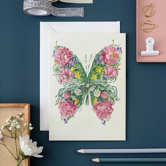 Floral butterfly card on a desk with stationery.